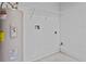 Basement laundry room with washer and dryer hookups, water heater, and shelving at 2977 Kokomo Loop, Haines City, FL 33844
