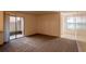 Bright living room with neutral walls and carpet flooring, access to patio at 3043 Antique Oaks Cir # 171, Winter Park, FL 32792