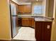 Galley kitchen with wood cabinets and stainless steel appliances at 3043 Antique Oaks Cir # 171, Winter Park, FL 32792