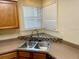 Kitchen features a corner sink and wood cabinets at 3043 Antique Oaks Cir # 171, Winter Park, FL 32792