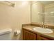 Bathroom vanity with sink and mirror, toilet and storage at 3043 Antique Oaks Cir # 171, Winter Park, FL 32792