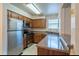 Kitchen boasts wood cabinets, stainless steel appliances, and ample counter space at 3043 Antique Oaks Cir # 171, Winter Park, FL 32792