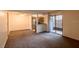Spacious living room with carpet flooring and sliding glass door to patio at 3043 Antique Oaks Cir # 171, Winter Park, FL 32792