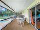 Screened porch with table and chairs overlooking the pool at 2405 Boy Scout Rd, Apopka, FL 32703