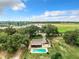 Aerial view showing home with pool, large yard, and distant construction at 2405 Boy Scout Rd, Apopka, FL 32703