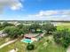 Aerial view of home with pool, large yard, and nearby construction at 2405 Boy Scout Rd, Apopka, FL 32703