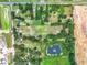 Aerial view showing a large lot with surrounding houses and a pond at 2405 Boy Scout Rd, Apopka, FL 32703