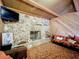 Living room with stone fireplace and wood-paneled walls at 2405 Boy Scout Rd, Apopka, FL 32703