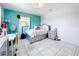 Bedroom with light gray platform bed and teal accent wall at 2405 Boy Scout Rd, Apopka, FL 32703
