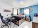 Dark-themed bedroom with a bed, desk, and gaming chair at 2405 Boy Scout Rd, Apopka, FL 32703