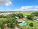 Aerial view of home with pool and large yard, distant construction at 2405 Boy Scout Rd, Apopka, FL 32703
