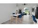 Dining area with a white table and four blue chairs at 2921 Omaha Dr, Deltona, FL 32738