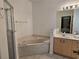 Bathroom with corner bathtub, shower, and double sink vanity at 14102 Indian Creek Dr, Kissimmee, FL 34759