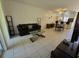 Open living room with leather sofa, coffee table, and dining area at 14102 Indian Creek Dr, Kissimmee, FL 34759