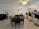 Bright dining area with a square table and four chairs, adjacent to kitchen at 14102 Indian Creek Dr, Kissimmee, FL 34759