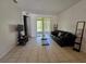 Cozy living room featuring a black leather sofa and a glass coffee table at 14102 Indian Creek Dr, Kissimmee, FL 34759