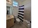 Clean bathroom with a shower/tub combo and striped curtain at 14102 Indian Creek Dr, Kissimmee, FL 34759
