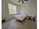 Simple bedroom with a double bed and tiled floors at 14102 Indian Creek Dr, Kissimmee, FL 34759