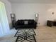 Living room with black leather sofa and coffee table at 14102 Indian Creek Dr, Kissimmee, FL 34759