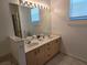 Bathroom with double vanity and large mirror at 14102 Indian Creek Dr, Kissimmee, FL 34759