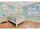 Serene bedroom with a queen-size bed and light teal walls at 4118 Isle Vista Ave, Belle Isle, FL 32812