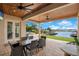 Covered patio overlooks lake, pool, and dock at 4118 Isle Vista Ave, Belle Isle, FL 32812