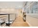 Light-filled hallway with hardwood floors and modern railing at 4118 Isle Vista Ave, Belle Isle, FL 32812