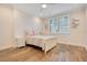 Charming bedroom with hardwood floors and a white bed at 4118 Isle Vista Ave, Belle Isle, FL 32812
