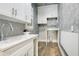 Bright laundry room with white cabinets and a modern sink at 4118 Isle Vista Ave, Belle Isle, FL 32812