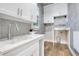 Bright laundry room with white cabinets and a modern sink at 4118 Isle Vista Ave, Belle Isle, FL 32812