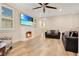 Cozy living room with fireplace, hardwood floors and two sofas at 4118 Isle Vista Ave, Belle Isle, FL 32812