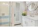 Charming bathroom with shiplap feature wall and walk in shower at 4118 Isle Vista Ave, Belle Isle, FL 32812