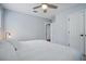 Bedroom with king bed, ceiling fan, and access to hallway at 2923 Ridley Ave, Orlando, FL 32814