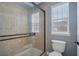 Bathroom with walk-in shower and tile surround at 2923 Ridley Ave, Orlando, FL 32814