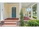 Brick front porch with columns and a teal front door at 2923 Ridley Ave, Orlando, FL 32814