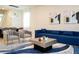 Bright living room features blue sofa and modern accents at 4458 Kaipo Rd, Davenport, FL 33897