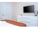 Bedroom with dresser and mounted TV at 4458 Kaipo Rd, Davenport, FL 33897
