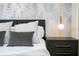 Bedroom with gray accents, a bed, and palm tree wallpaper at 4458 Kaipo Rd, Davenport, FL 33897