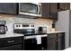 Sleek kitchen features stainless steel appliances and granite countertops at 4458 Kaipo Rd, Davenport, FL 33897