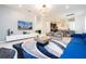 Open concept living room with large TV and modern decor at 4458 Kaipo Rd, Davenport, FL 33897