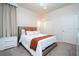 Comfortable bedroom with white bedding and burnt orange throw at 4458 Kaipo Rd, Davenport, FL 33897