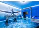 Game room with foosball, pool table, and Avatar-themed murals at 4458 Kaipo Rd, Davenport, FL 33897