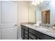 Bathroom with double sinks, granite countertop, and dark brown vanity at 4458 Kaipo Rd, Davenport, FL 33897