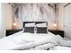 Bedroom with a comfortable bed and palm tree wallpaper at 4458 Kaipo Rd, Davenport, FL 33897