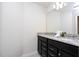 Bathroom with granite countertop, double sinks and dark cabinets at 4458 Kaipo Rd, Davenport, FL 33897