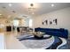 Open concept living room, with adjacent dining and kitchen areas at 4458 Kaipo Rd, Davenport, FL 33897