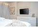 Bedroom with a dresser, TV, and artwork at 4458 Kaipo Rd, Davenport, FL 33897