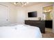 Spacious bedroom with dresser, TV, and ensuite bathroom access at 4458 Kaipo Rd, Davenport, FL 33897