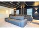 Modern home theater with tiered seating and ambient lighting at 4458 Kaipo Rd, Davenport, FL 33897