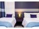Bedroom with two twin beds, nightstand, and purple accents at 4458 Kaipo Rd, Davenport, FL 33897